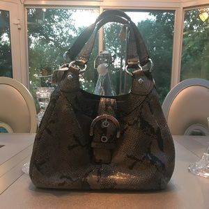 Coach bag with belt buckle